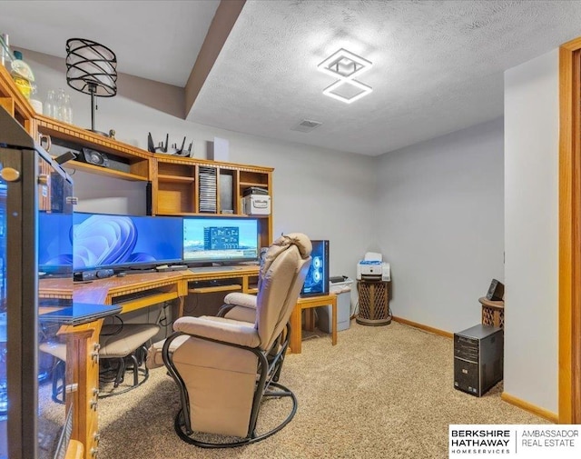 home office featuring carpet and a textured ceiling