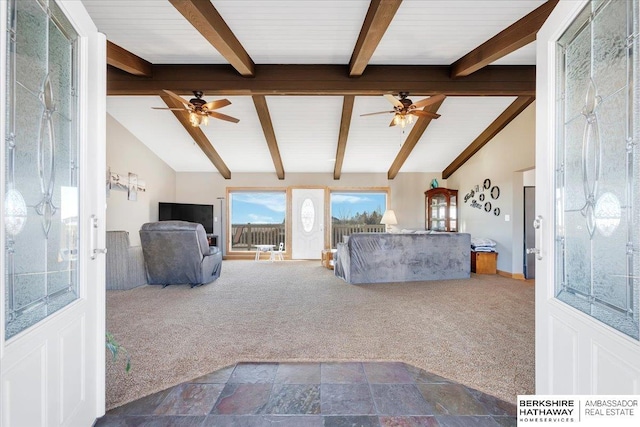 unfurnished living room featuring carpet, vaulted ceiling with beams, and ceiling fan