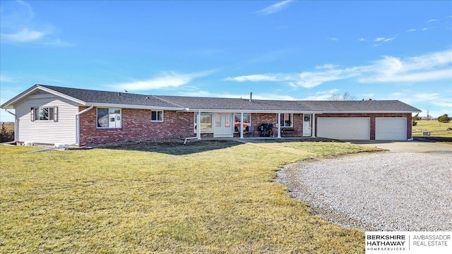 ranch-style house with a garage and a front lawn