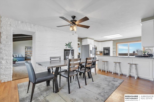 dining space featuring ceiling fan and light hardwood / wood-style flooring