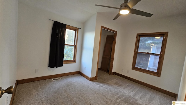 unfurnished bedroom featuring light carpet, ceiling fan, and lofted ceiling