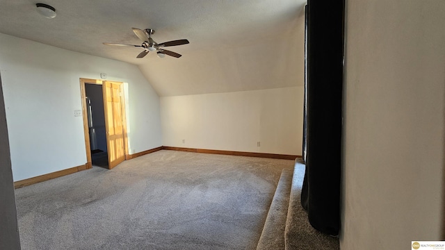 additional living space with ceiling fan, carpet floors, and lofted ceiling