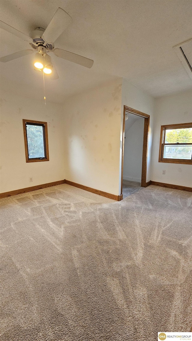 unfurnished room with carpet flooring and ceiling fan