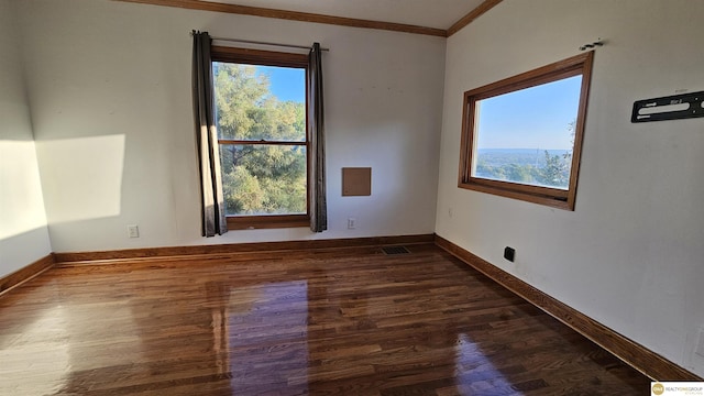 unfurnished room featuring crown molding and dark wood-type flooring