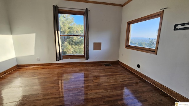 unfurnished room featuring dark hardwood / wood-style floors and ornamental molding