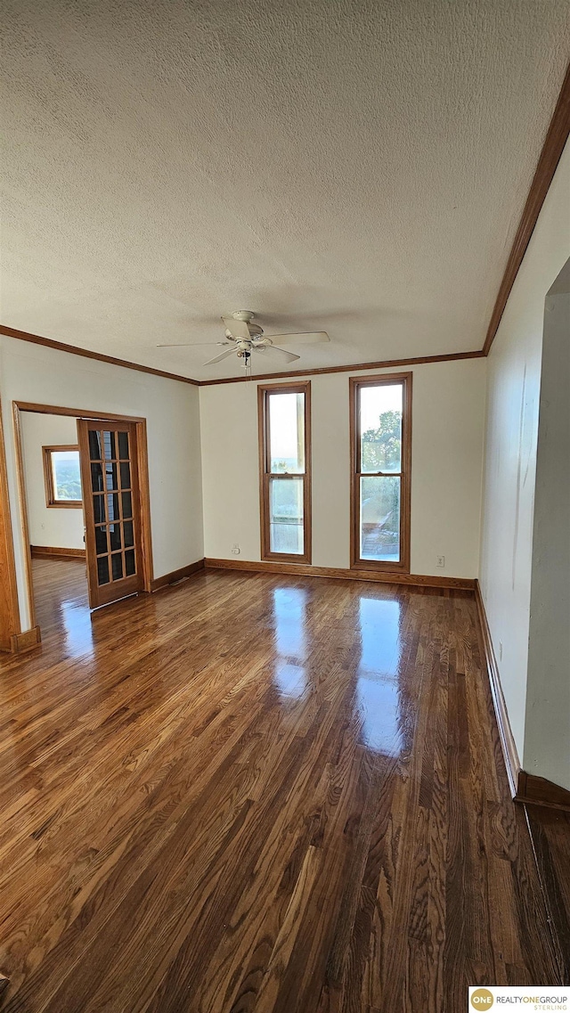 unfurnished living room featuring a textured ceiling, ceiling fan, crown molding, and dark hardwood / wood-style floors