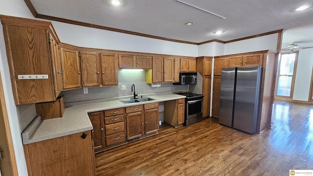 kitchen featuring dark hardwood / wood-style flooring, sink, stainless steel appliances, and ornamental molding