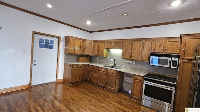 kitchen with sink, tasteful backsplash, dark hardwood / wood-style flooring, crown molding, and appliances with stainless steel finishes