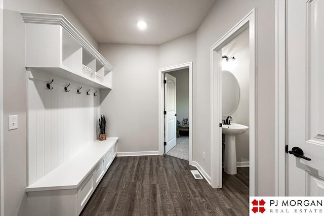 mudroom with dark hardwood / wood-style floors and sink