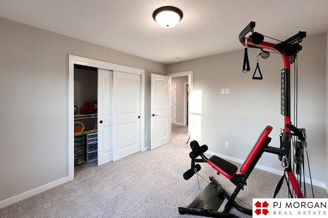 workout room with carpet and a textured ceiling