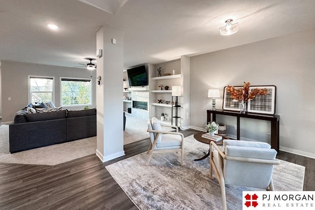 living room featuring ceiling fan and dark hardwood / wood-style floors