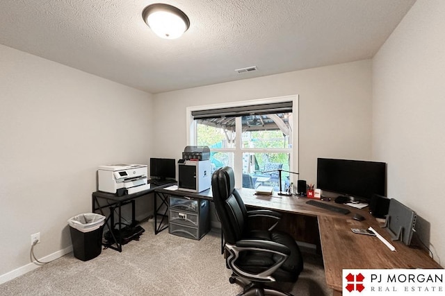 office area featuring light colored carpet and a textured ceiling