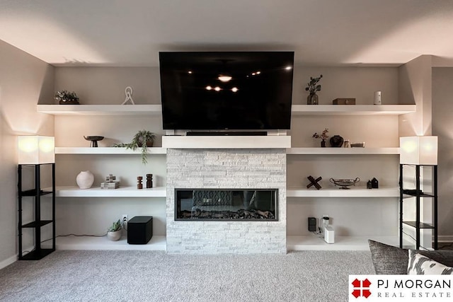 carpeted living room featuring a fireplace