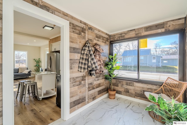 interior space with wood walls and a healthy amount of sunlight