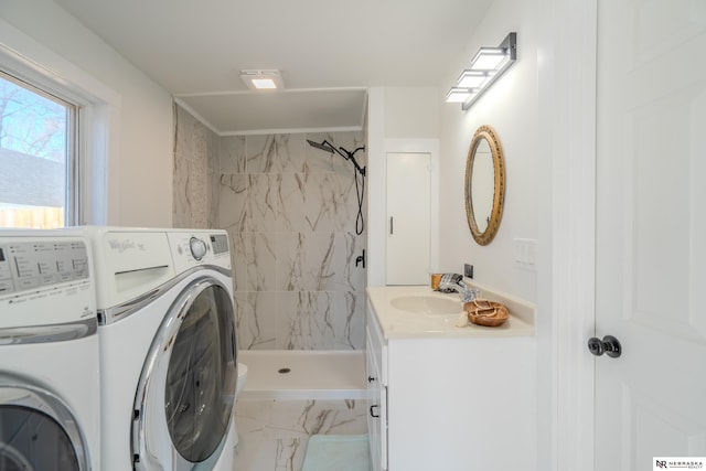 laundry area with washing machine and clothes dryer and sink