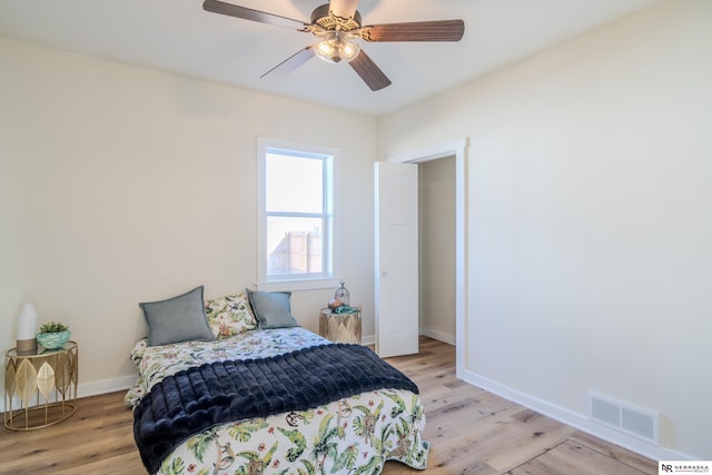 bedroom with ceiling fan and light hardwood / wood-style floors