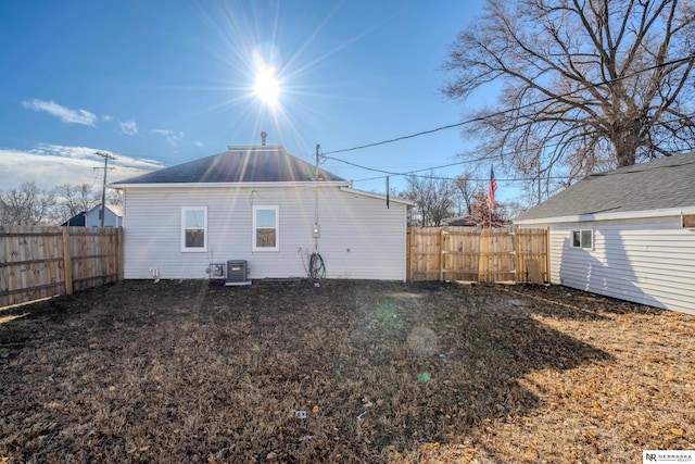 rear view of property with central AC