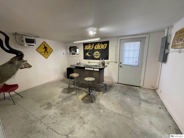 bar with concrete flooring and electric panel