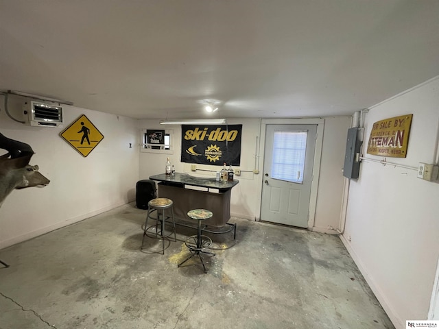 bar featuring concrete floors and electric panel