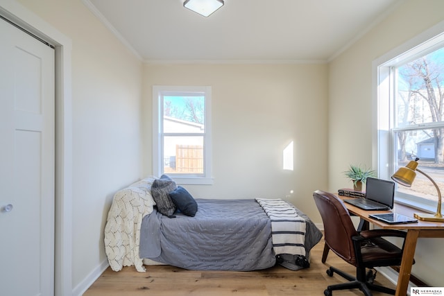 bedroom with light wood-type flooring and ornamental molding