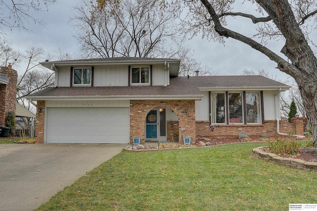 split level home with a front yard and a garage