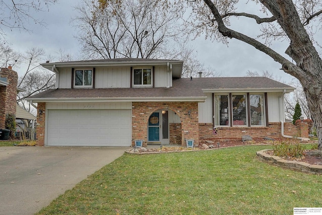 split level home with a front yard and a garage