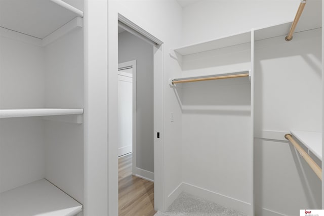 walk in closet featuring light hardwood / wood-style floors