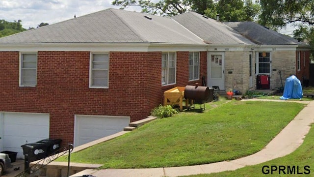 view of front of property with a front yard and a garage