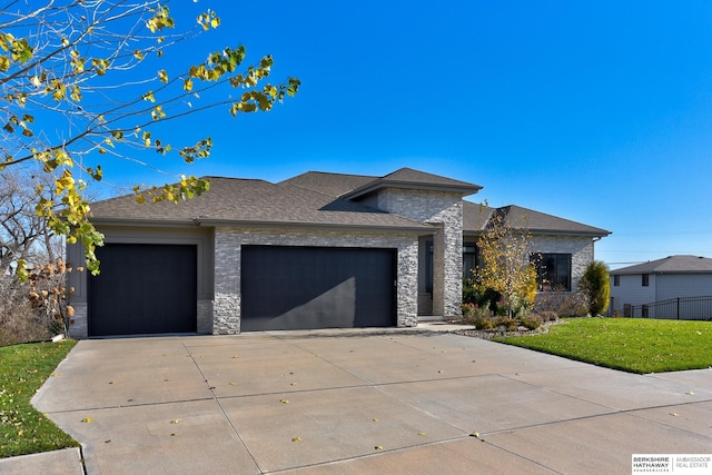 view of front facade with a garage and a front lawn