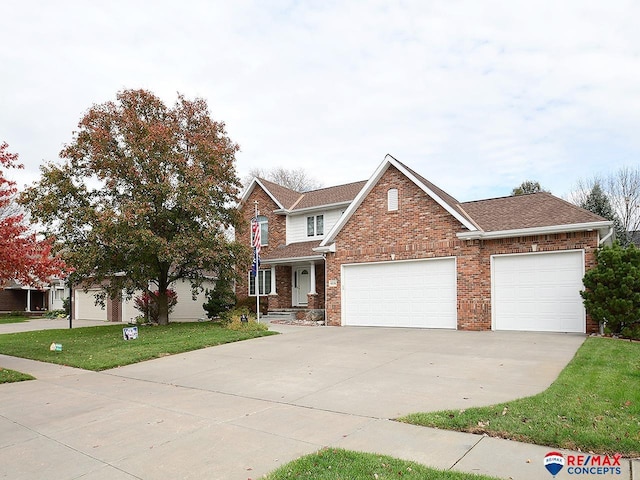 view of front of house featuring a front lawn and a garage