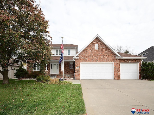 view of property with a front yard and a garage