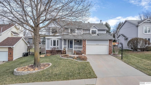 view of front of house with covered porch, a garage, and a front lawn