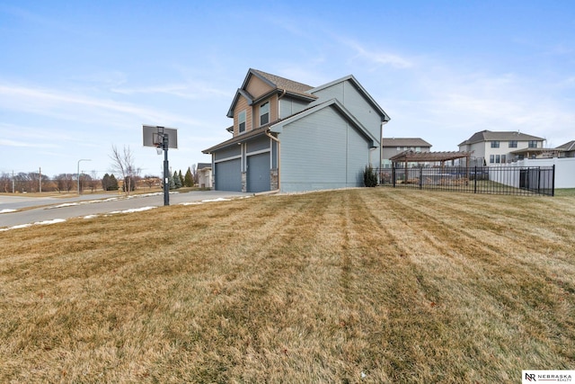 view of side of home with a lawn and a garage