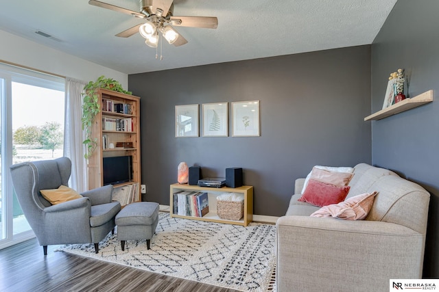 living area featuring ceiling fan and hardwood / wood-style floors