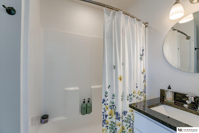 bathroom with curtained shower and vanity