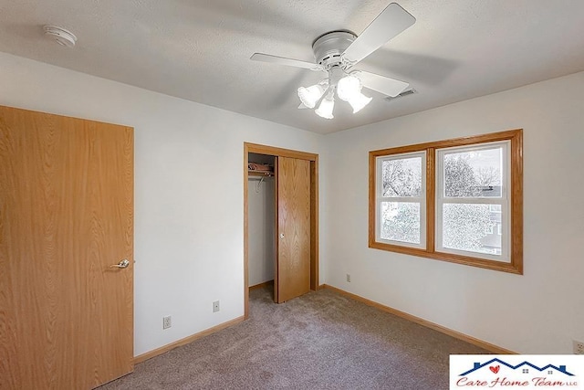 unfurnished bedroom with ceiling fan, a closet, and carpet floors