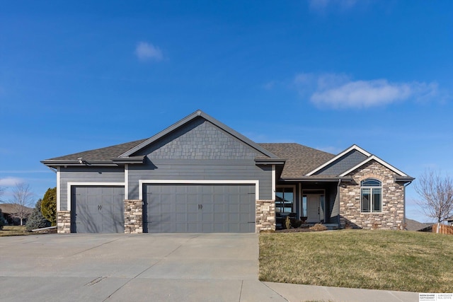 craftsman-style house featuring a front lawn and a garage