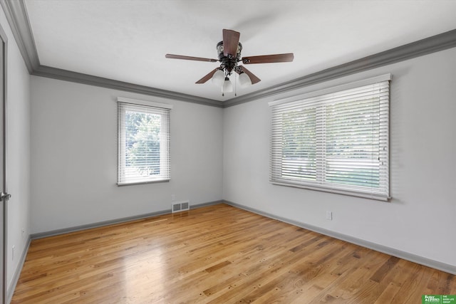 empty room featuring light wood-type flooring, ceiling fan, and ornamental molding