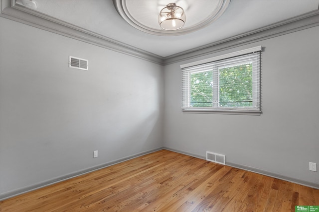 unfurnished room featuring light hardwood / wood-style floors and ornamental molding