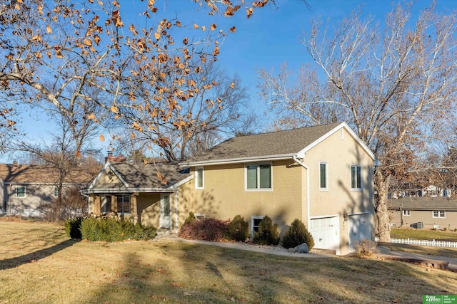 view of front of property with a front yard and a garage