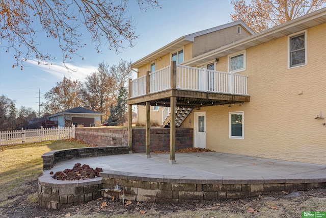 rear view of house featuring a patio, an outdoor fire pit, and a wooden deck