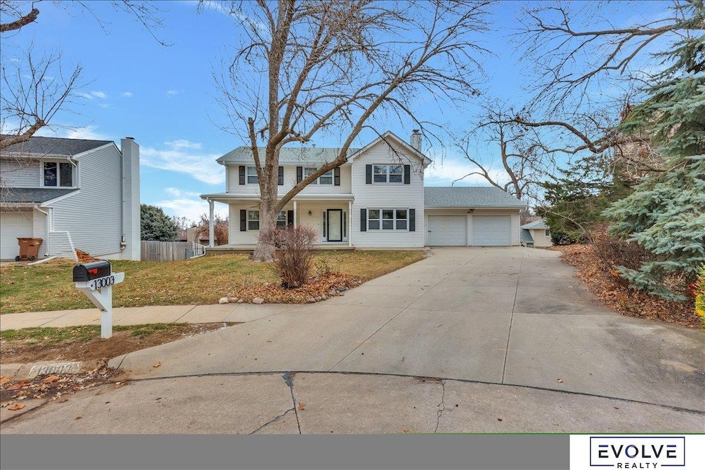 view of front of home featuring a front yard and a garage