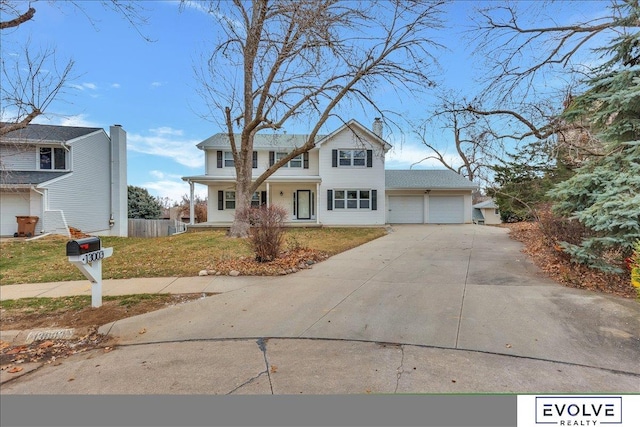 view of front of home featuring a front yard and a garage