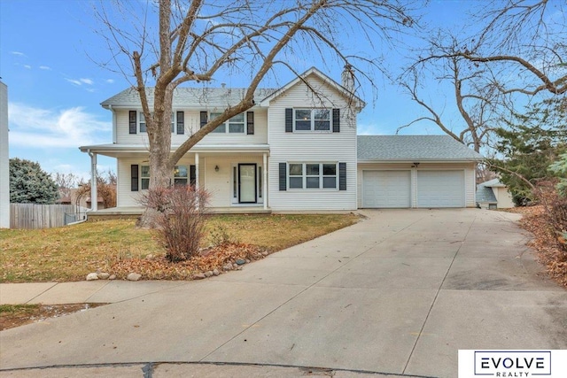 view of front of house featuring a porch, a front yard, and a garage