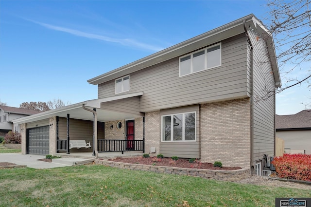 view of front of property with covered porch, a front yard, and a garage