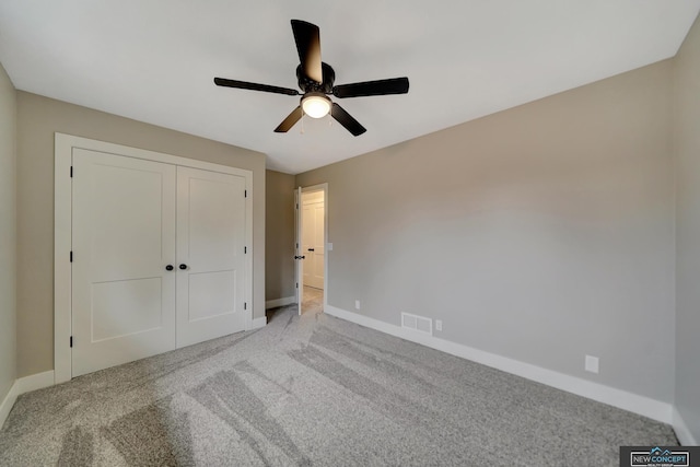 unfurnished bedroom with light carpet, a closet, and ceiling fan