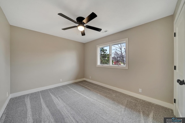 carpeted spare room with ceiling fan