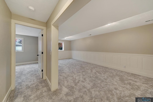 interior space with light colored carpet and a healthy amount of sunlight