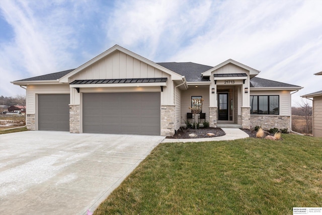 view of front of home with a garage and a front lawn