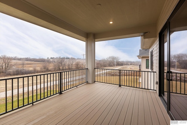 wooden deck with a rural view